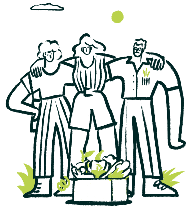 Tres personas abrazadas con una caja de productos delante